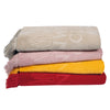 Folded Greenwich Polo Club 3657 cotton beach towels in beige, grey, pink, yellow and red.