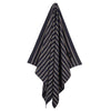 Hanging Greenwich Polo Club 4077 black cotton beach towel with fine beige stripes and fringed ends.