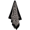 Hanging Greenwich Polo Club 5237 black and taupe animal-print cotton beach towel with fringed ends.