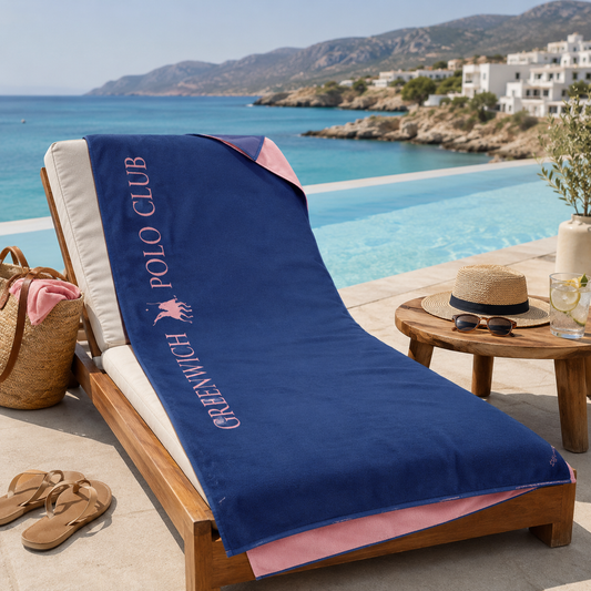 Greenwich Polo Club 5210 blue and pink microfiber beach towel laid across a poolside sun lounger in Sitia, Crete.