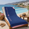 Greenwich Polo Club 5210 blue and pink microfiber beach towel laid across a poolside sun lounger in Sitia, Crete.