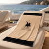 Greenwich Polo Club cotton beach towel 4046 in beige and black displayed on a yacht sun lounger in Sitia, Crete.