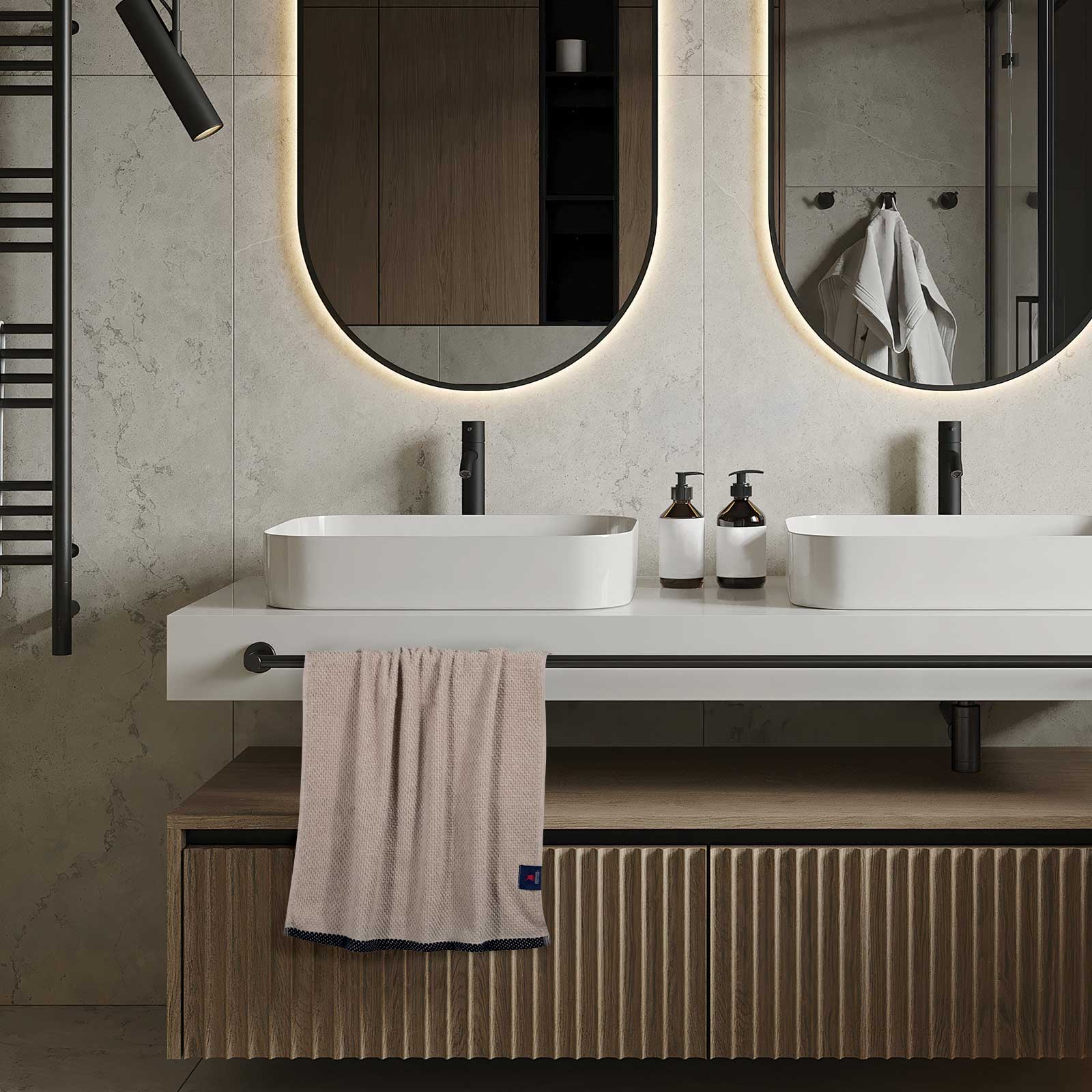 Beige Greenwich Polo Club Cozy 4130 cotton towel hanging in a modern bathroom, featuring a textured weave, black decorative border and discreet Greenwich Polo Club logo for a timeless unisex look.