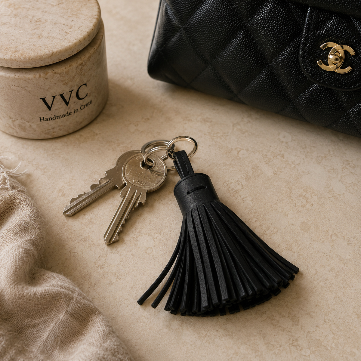 Handmade black leather tassel key chain by VVC with stainless steel key ring, sustainable leather accessory from Sitia, Crete
