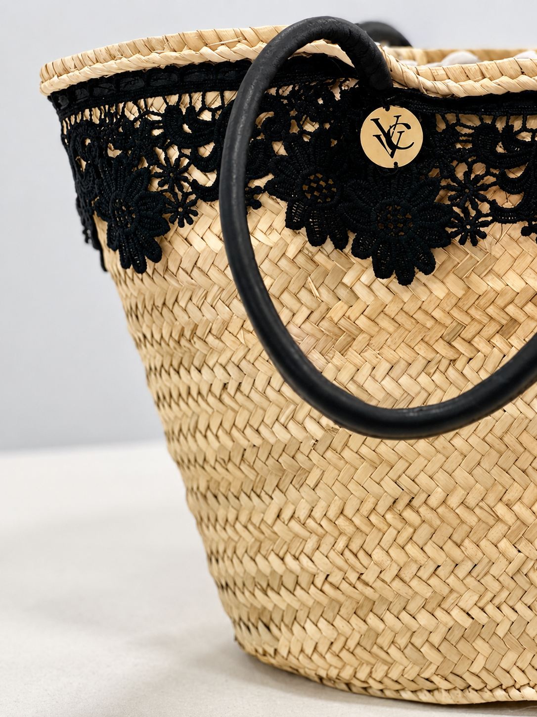 Handmade raffia beach basket with black lace trim and luxury tote bag design