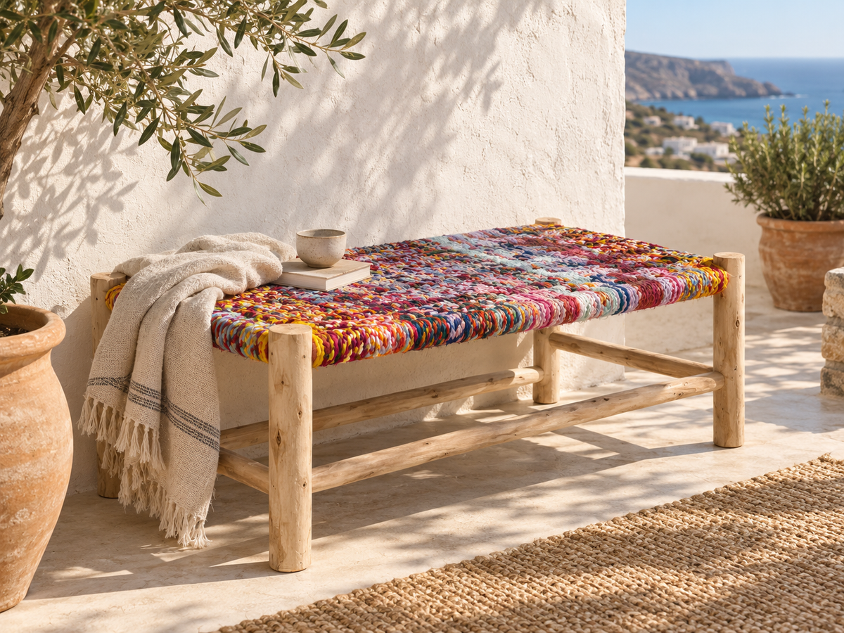 Colourful handmade bench styled on a sunlit Mediterranean terrace in Sitia, Crete.
