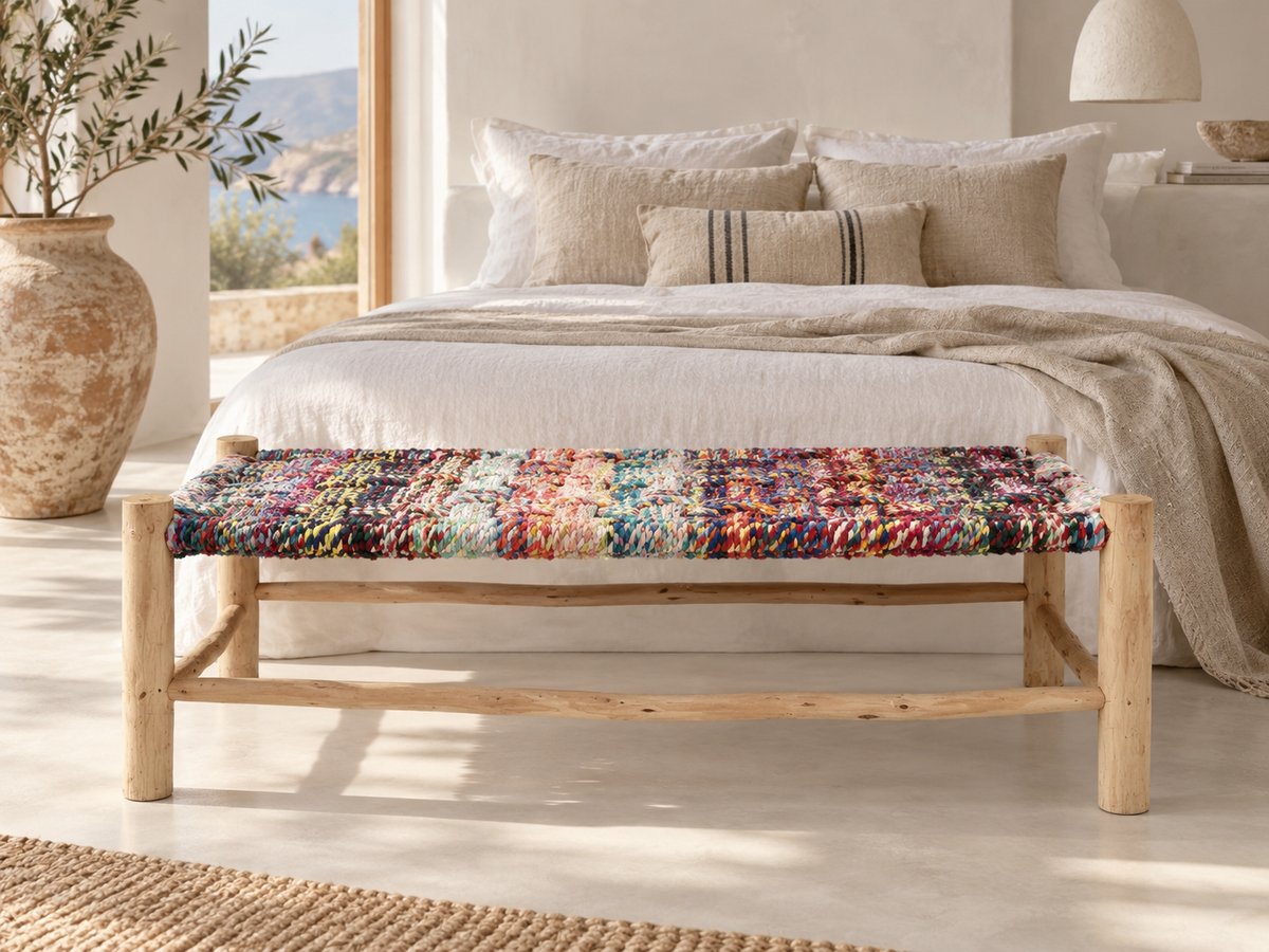 Colourful handmade textile bench styled at the foot of a neutral Mediterranean bedroom