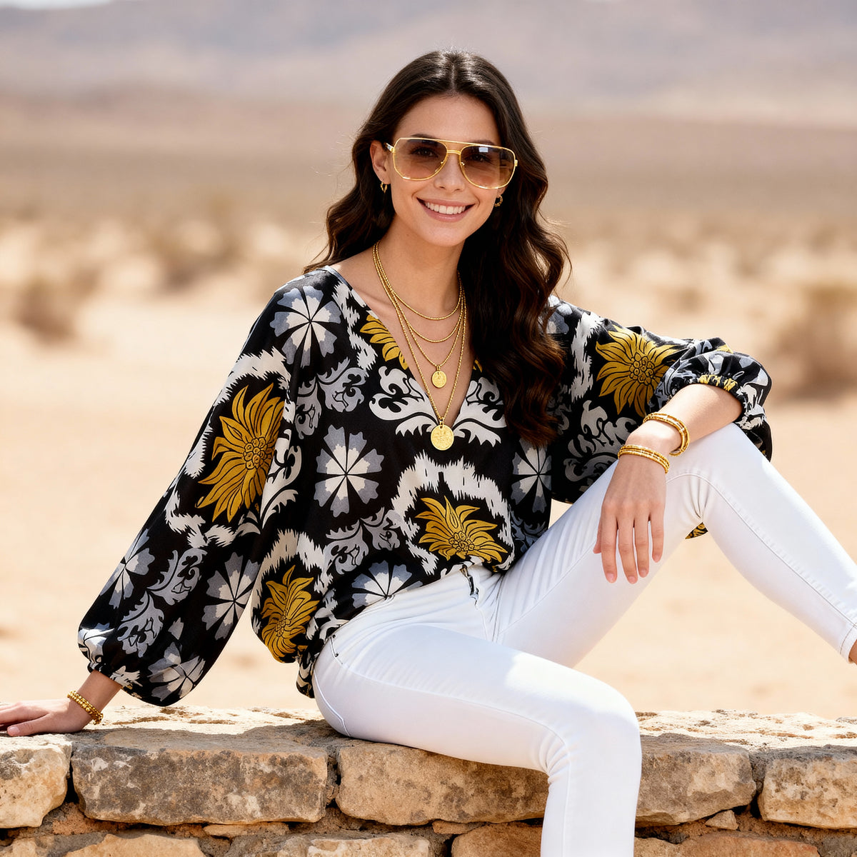 Imza black and yellow palm print blouse styled with white pants, gold jewellery and sunglasses for a chic summer holiday outfit