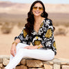 Imza loose fit palm tree summer blouse in black yellow grey and white styled with white trousers for hot weather travel and resort looks in Sitia Crete