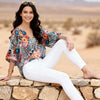 Imza zebra floral blouse with orange pink and turquoise poppy print styled with white trousers for a relaxed Greek summer outfit