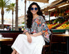 Loose fit zebra floral blouse by Imza styled as a 2026 Greek island lifestyle look with white bottoms and summer accessories