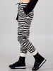 Side view of the Kasha beige-and-black zebra-print jogger pants showing their tapered legs and elastic ankle cuffs.