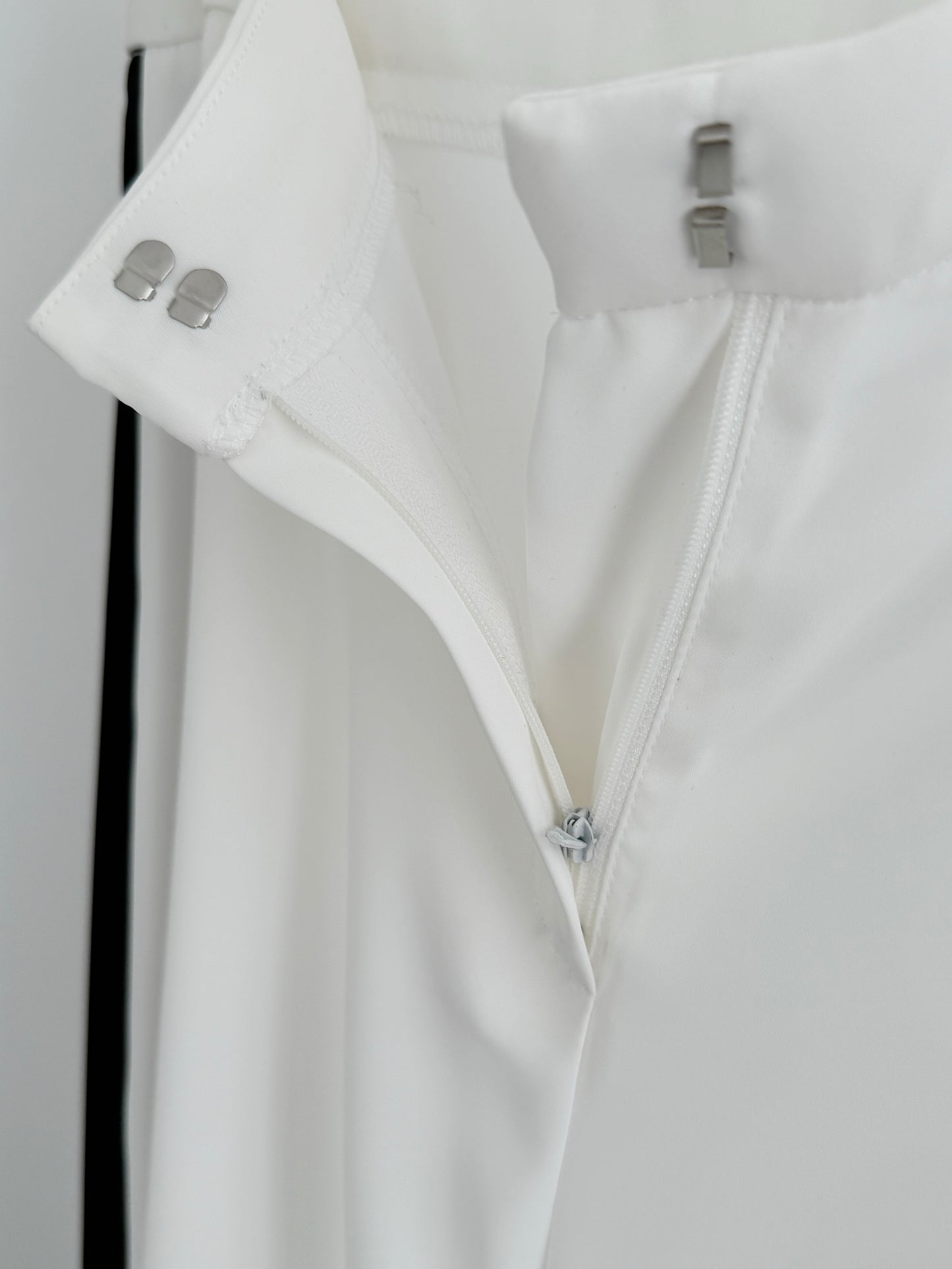 Detail view of Kasha Marlene trousers with hidden zip, discreet hook fastening, lined interior and premium flowing fabric
