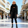 Full-length view of the Kenco black long sequin blazer styled with black leggings and a beige top in Sitia, Crete.