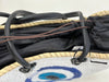 Close-up of large white sequin evil eye basket with black handles, straw rim and blue evil eye design.