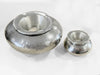 Two sizes of hand-forged, hammered aluminum ashtrays, one large and one small, with a shiny silver finish.