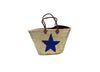 A handmade gold basket beach bag - shopping bag shoulder bag tote bag with a navy blue sequin star decoration and a brown leather handle.