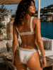 Back view of LocoLoco silver and white crochet bikini, handmade Brazilian swimwear styled in a luxury Mediterranean resort setting.