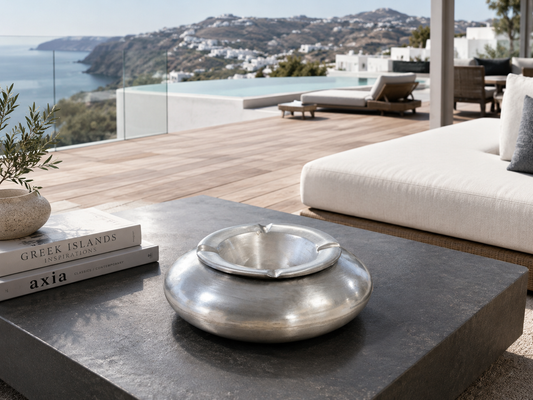 Large 24x24 cm aluminium windproof design ashtray with silver finish, styled in a luxury outdoor lounge in Greece, available at VVC SHOP Sitia Crete.