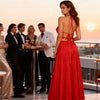 Back view of the Melody red macramé top showing its tied neckline and backless design, styled with a red maxi skirt.
