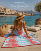 MiandMi two-sided pareo beach towel with coral tie-dye design displayed at a luxury seaside location in Sitia Crete