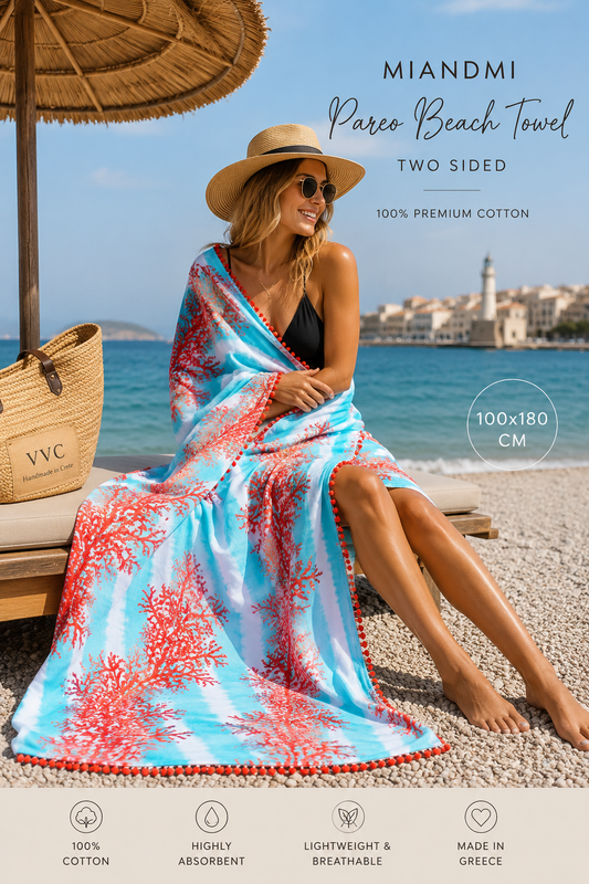 MiandMi coral pareo beach towel lifestyle image in Sitia Crete with blonde woman showcasing luxury Greek beach fashion