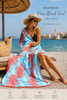 MiandMi coral pareo beach towel lifestyle image in Sitia Crete with blonde woman showcasing luxury Greek beach fashion