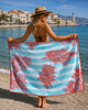 Premium cotton beach towel with coral pattern displayed overlooking the harbour in Sitia Crete