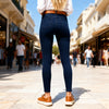 Back view of a woman wearing Miss Sister dark blue body-shaping stretch denim jeggings in Sitia, Crete.
