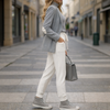 Side view of off-white slim fit fine-knit wool jogger trousers with elastic ankle cuffs