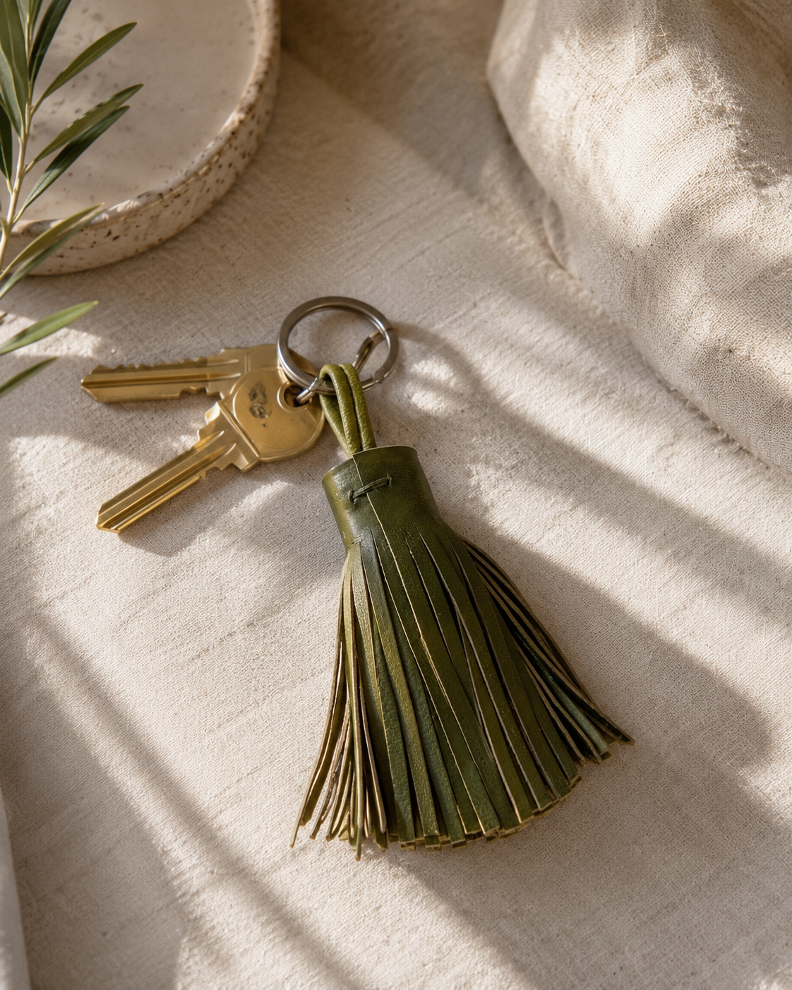 Olive green leather keyring with tassel detail inspired by Crete, stylish everyday accessory available in Sitia, Crete, Greece.