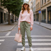 Front view of a woman wearing olive-green slim-fit fine-knit wool jogger trousers with an elastic waistband.