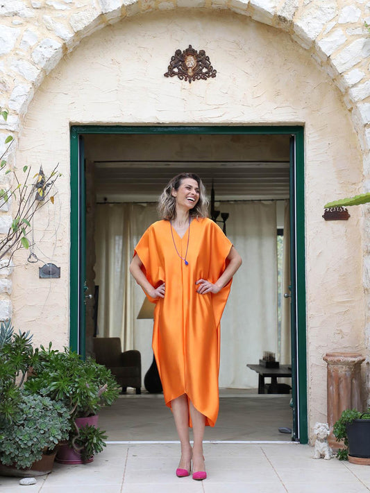 Orange plus-size kaftan by Pane Line with batwing sleeves, V-neckline and asymmetric mullet hem, available at VVC SHOP Sitia, Crete