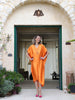 Orange plus-size kaftan by Pane Line with batwing sleeves, V-neckline and asymmetric mullet hem, available at VVC SHOP Sitia, Crete