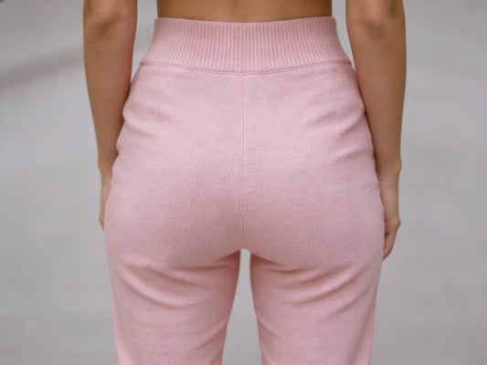 Close-up back view of soft pink slim fit wool trousers showing elastic waistband detail