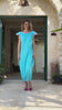 Side view of turquoise and pink structured maxi dress highlighting slimming waist and shoulder pad design, made in Greece by VVC™