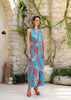 Model walking in coral and turquoise backless jumpsuit by Berrin, showing movement and luxury flow of the fabric.