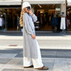 Model wearing light grey cardigan styled with pink dress, Sitia Port look