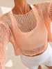 Close-up of the soft peach cropped summer top showing its wide neckline and extra-large open-knit texture.