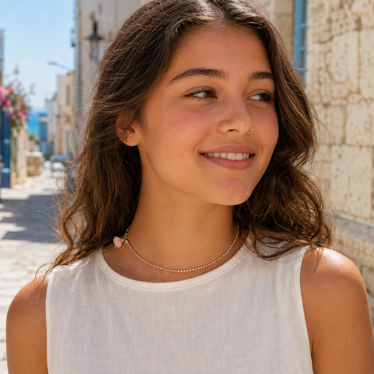 Teen model wearing a rose-nude rhinestone choker with blush flower by VVC Shop Sitia, Crete.