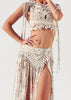 Close view of the Tulum cotton macramé wrap skirt with shell and sequin details, adjustable waist tie and long fringes by VVC.