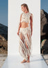 Side walking view of the Tulum macramé fringe skirt showing its flowing cotton fringes and bohemian festival style.