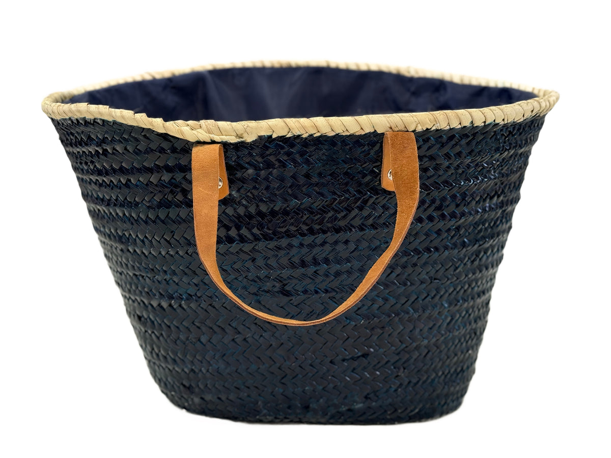 Back view of handmade VVC™ nautical beach basket with natural woven palm leaf finish and leather handles. Mediterranean shopping tote and beach bag available at the VVC Shop in Sitia, Crete.
