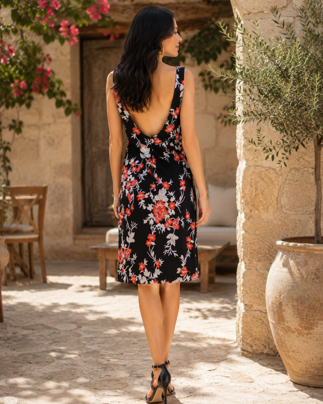Back view of VVC backless black floral mini dress with deep open back, red and white floral pattern and elegant summer style, made in Greece