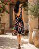 Back view of VVC backless black floral mini dress with deep open back, red and white floral pattern and elegant summer style, made in Greece