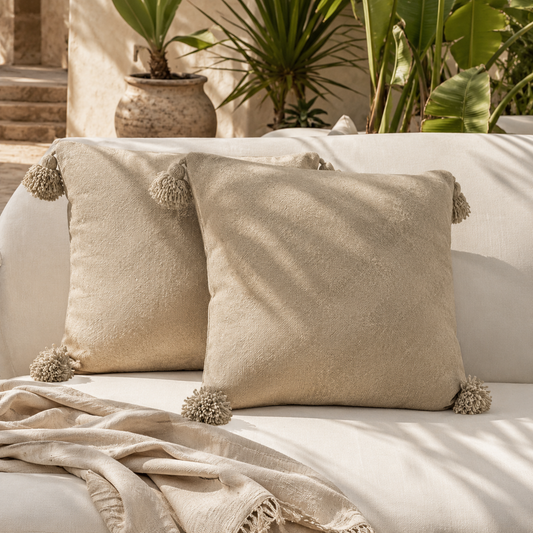 Beige VVC cotton cushion cover with decorative pom poms, handmade Mediterranean summer pillowcase for sofa, bedroom, terrace and outdoor styling in Sitia Crete