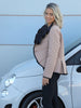 Side view of the VVC beige diamond-quilt puffer jacket showing its fan-shaped collar and black trim.