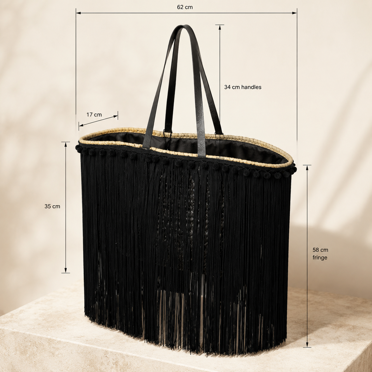 VVC™ handmade black satin fringe raffia basket close-up showing 62 × 35 × 17 cm dimensions, 34 cm handles and 58 cm fringe.