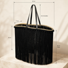 VVC™ handmade black satin fringe raffia basket close-up showing 62 × 35 × 17 cm dimensions, 34 cm handles and 58 cm fringe.
