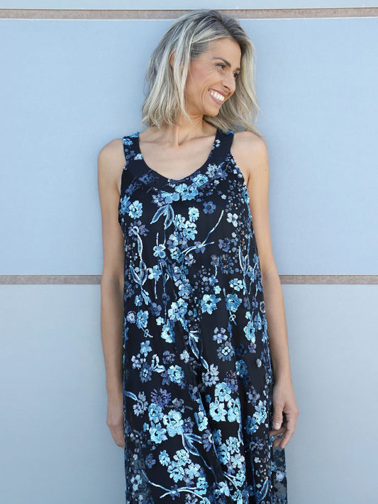 Model wearing the VVC blue-and-black hand-embroidered floral sequin mullet dress, front view.